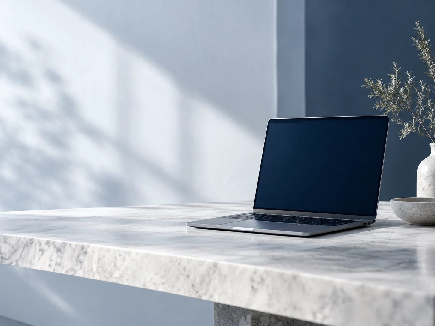 Desk with an open laptop in cool daylight
